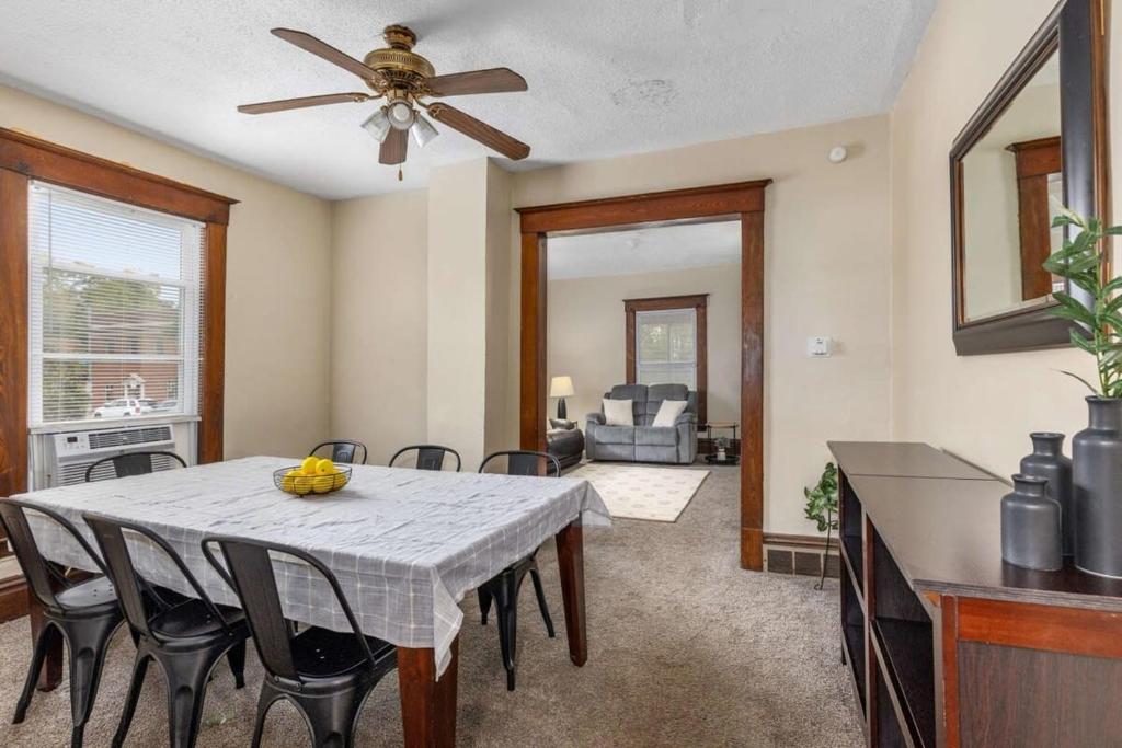 a dining room with a table and a ceiling fan at Charming 4BR Westside Home in Beer City USA in Grand Rapids