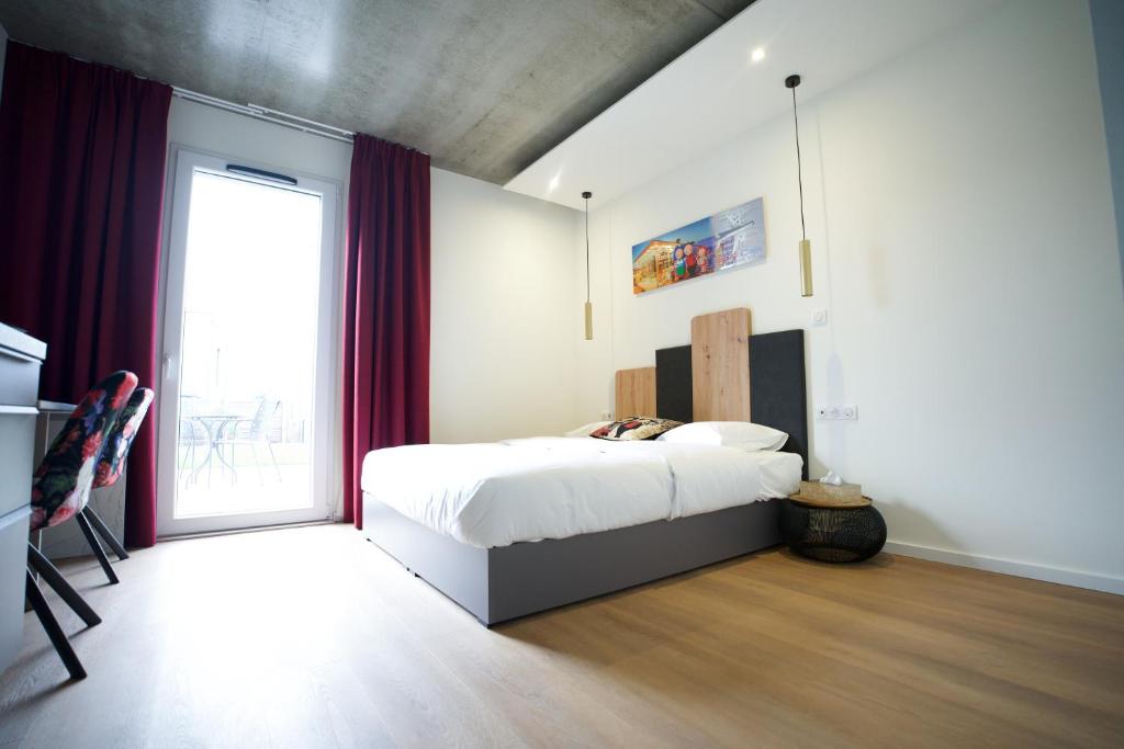 Postel nebo postele na pokoji v ubytování Arrow Hôtel