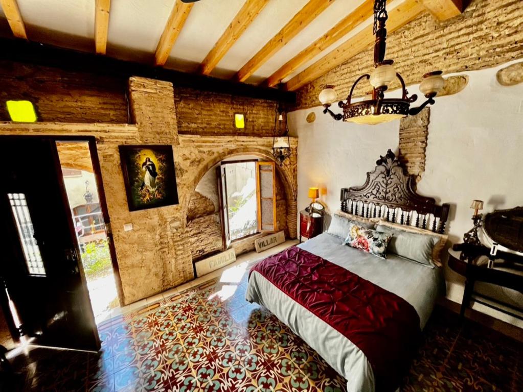 a bedroom with a large bed in a room at Oliva Courtyard Guesthouse in Oliva
