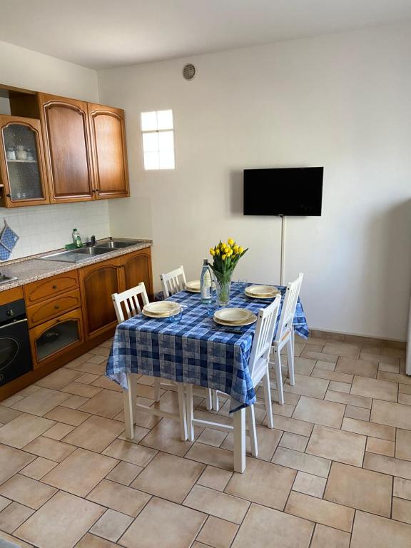 a kitchen with a table with a blue and white table cloth at Regina House Cattolica in Cattolica