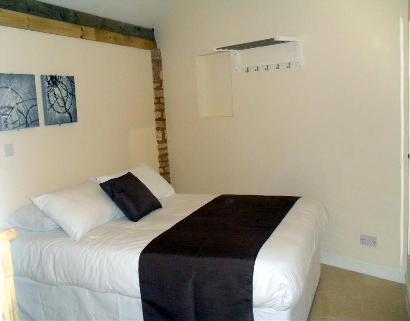 a bedroom with a large white bed in a room at Otters Holt at Tove Valley Cottages in Towcester