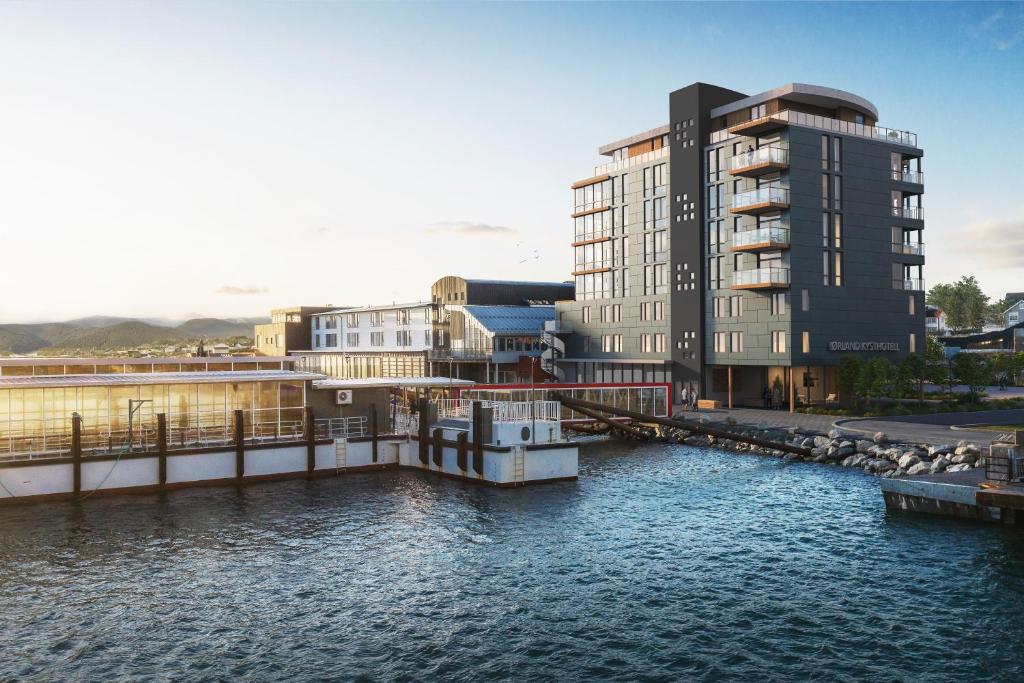 a rendering of a building next to a body of water at Ørland Kysthotell in Brekstad