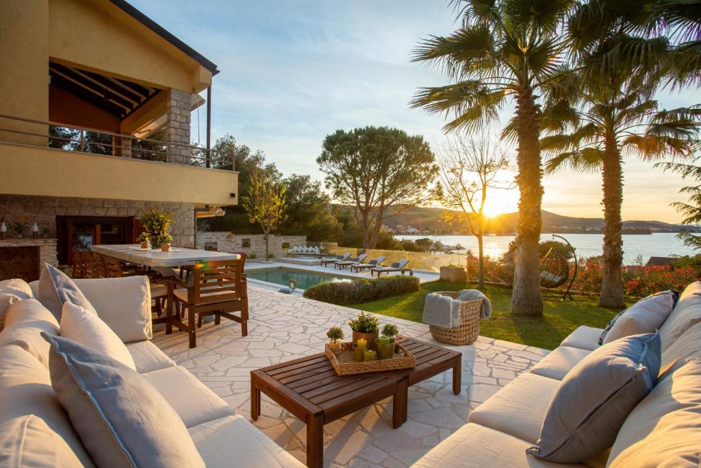 a patio with a couch and a table at Villa Barotul with pool in Mrljane