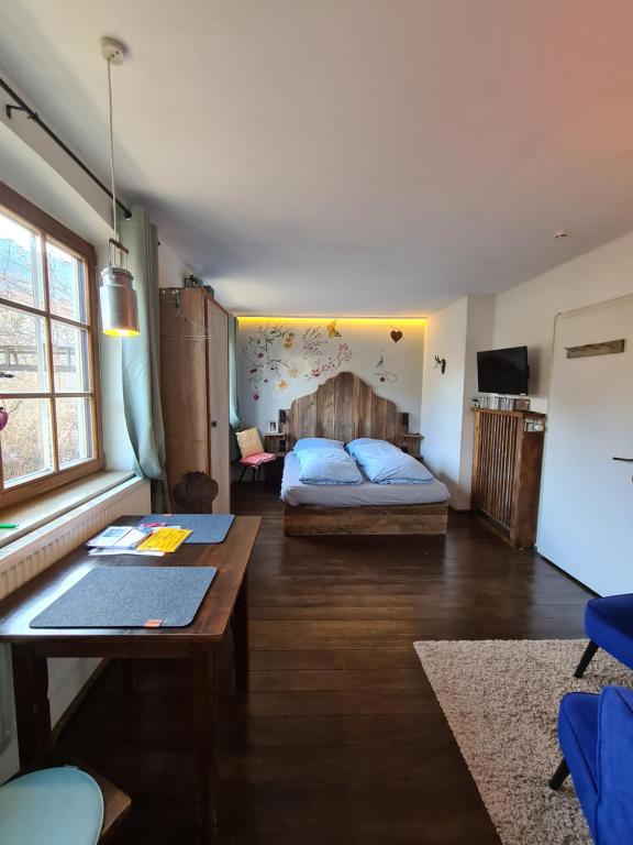 sypialnia z łóżkiem i stołem w pokoju w obiekcie 'Sissi' ein zaubehaftes Apartement im modernen Landhausstil w mieście Oberammergau