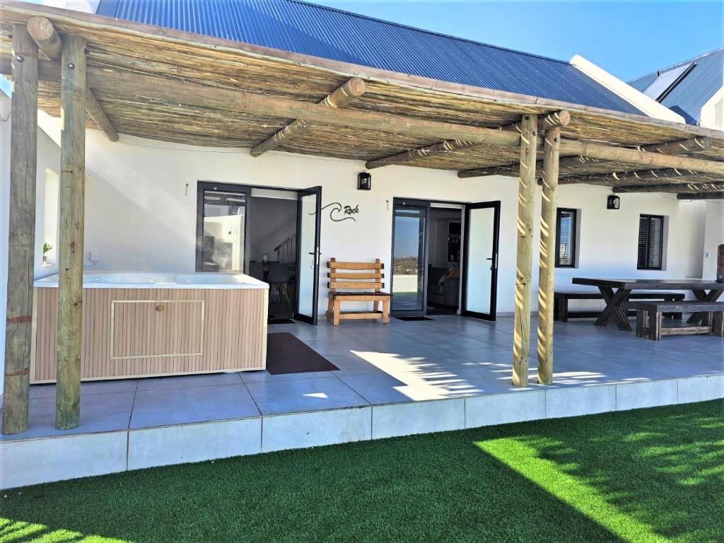 an outdoor deck with a wooden pergola at C-Rock Holiday Home Jacobs Bay in Jacobs Bay