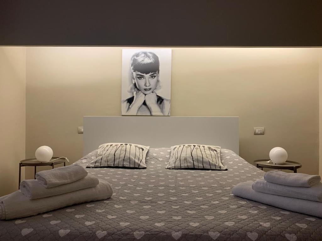 a bedroom with a bed with two pillows on it at Greige Apartment in La Spezia