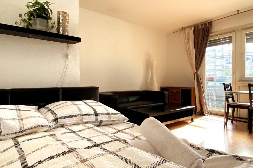 ein Schlafzimmer mit einem Bett und ein Wohnzimmer in der Unterkunft Simplex Apartments Am Konzerthaus in Karlsruhe