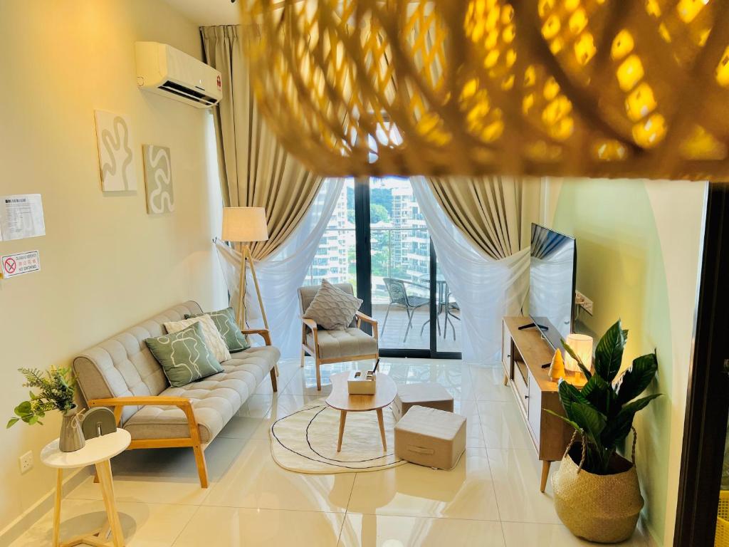 a living room with a couch and a tv at Muji-Inspired 2BR 2BA Apartment, 8 Mins to CIQ, Sleeps 2-6 in Johor Bahru