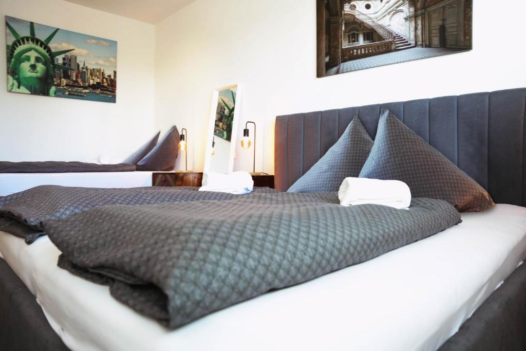 a bedroom with a large bed with a gray comforter at City Appartement Salzburg in Salzburg
