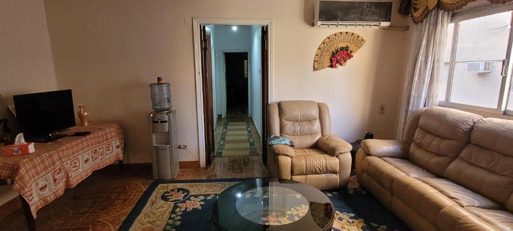A television and/or entertainment centre at CozyHome 3BR Place Nasr City