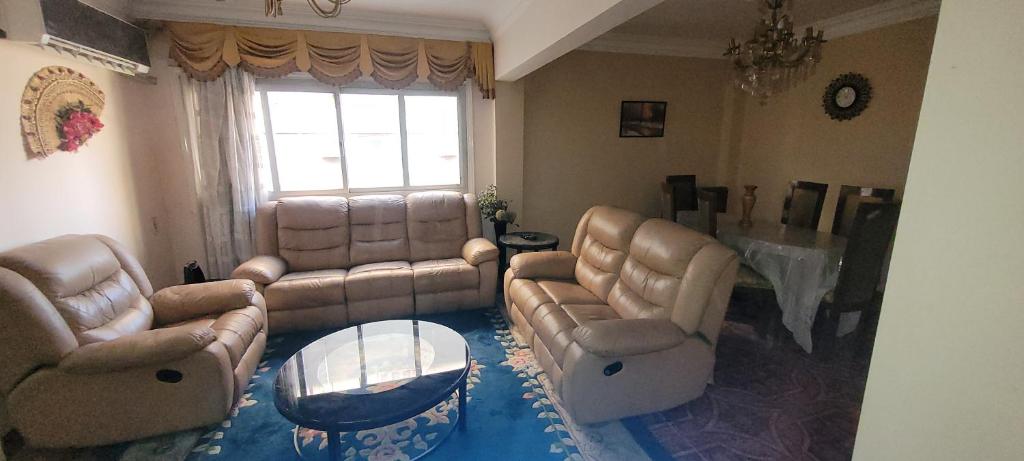 a living room with couches and a table at Cozy 3BR Place Nasr City in Cairo