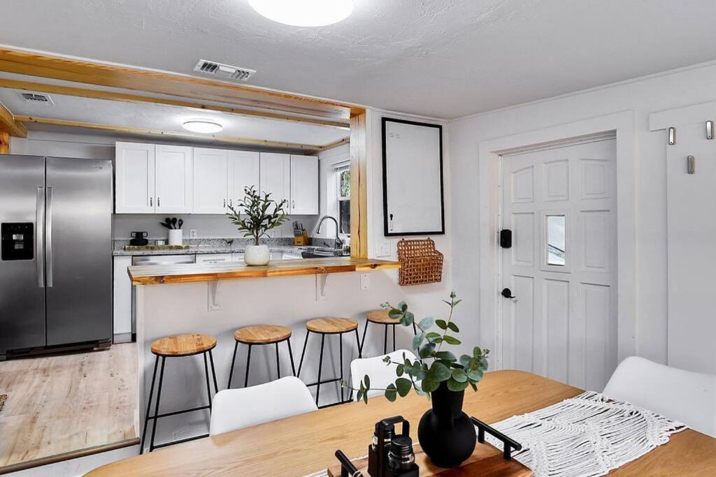 a kitchen with a table and some stools in it at Central, Cozy Retreat in Vero Beach