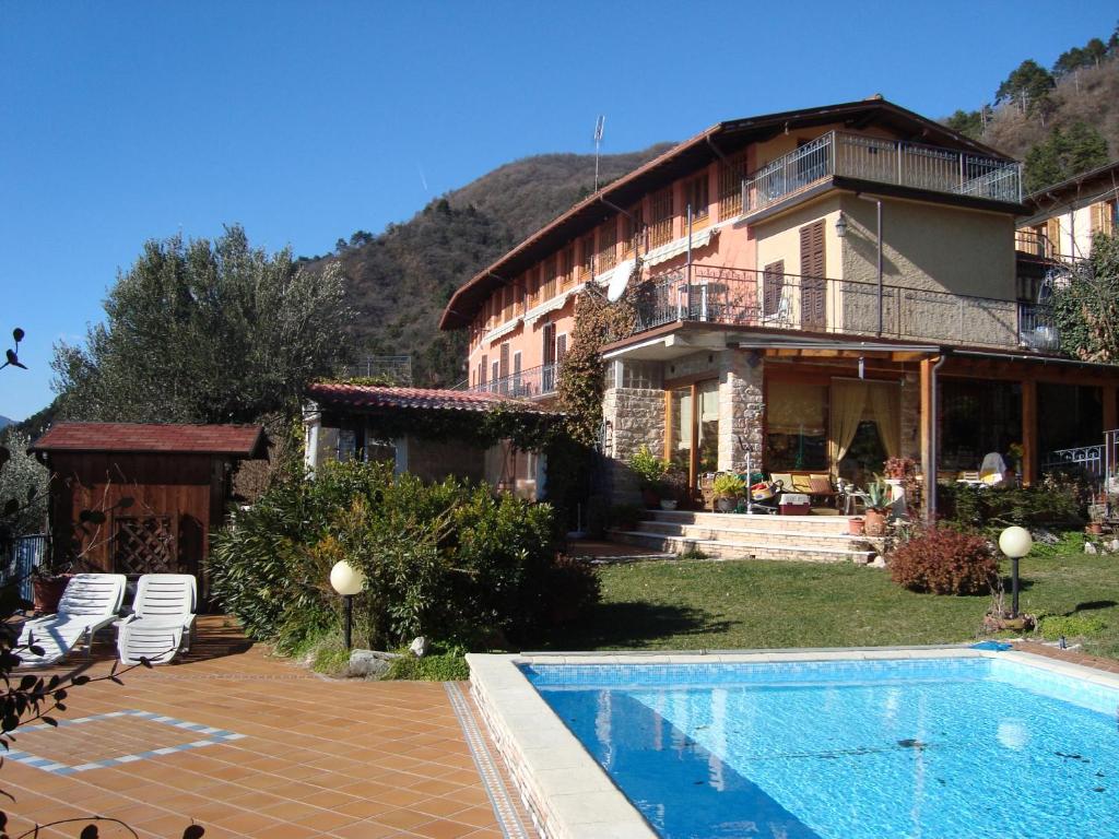 a house with a swimming pool in front of it at Apt Giada Salò magic view in Salò