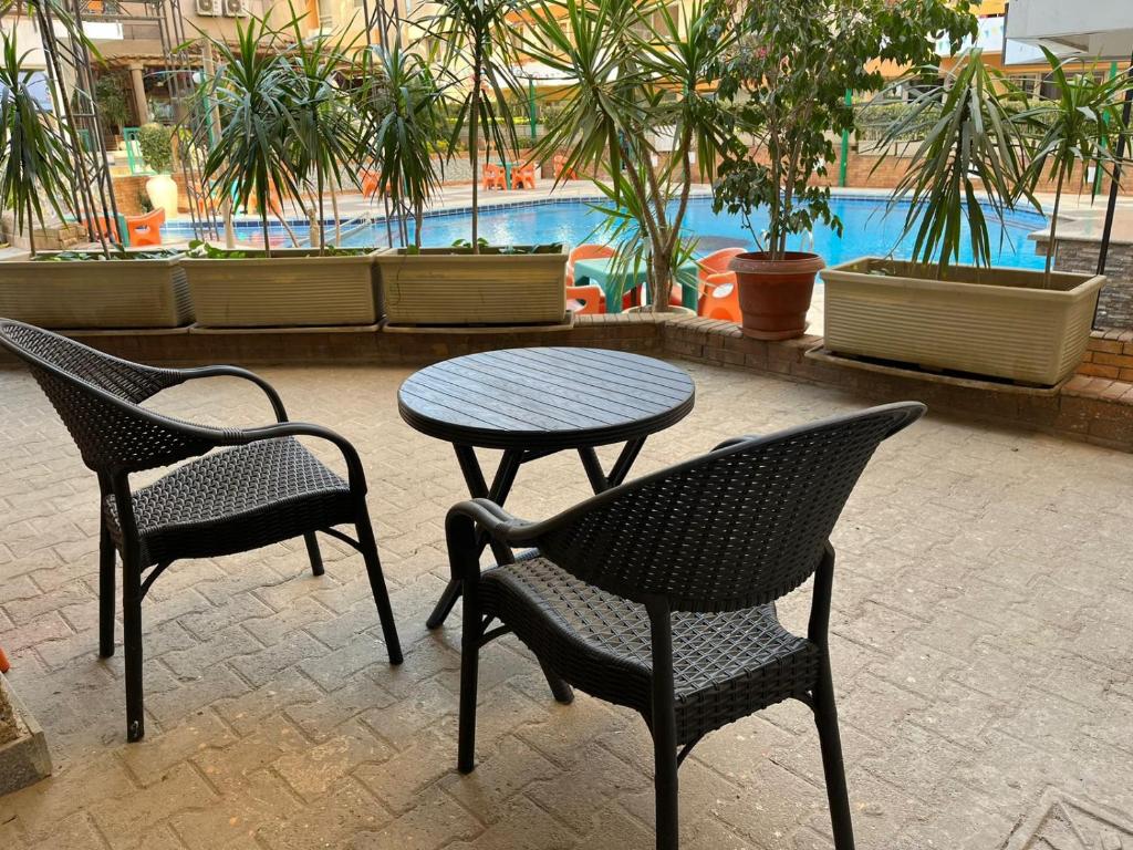 two chairs and a table and a table and chairs at Monte cairo Pool View in Cairo