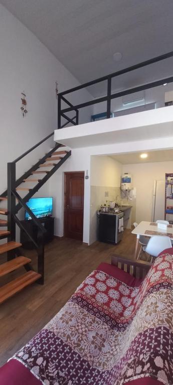 a bedroom with a loft bed and a staircase at Shanti Loft in Concepción del Uruguay