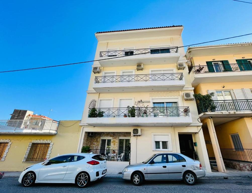two cars parked in front of a building at Dreamy Luxury Studio in Nafpaktos