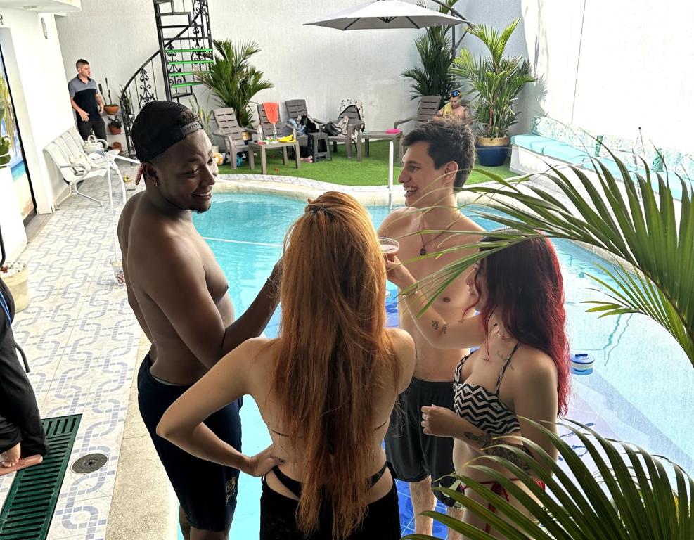 a group of people standing by a swimming pool at The View Hostel & Lounge in Cali