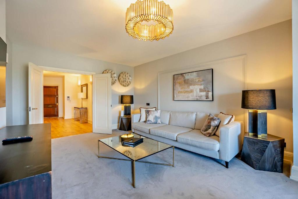 a living room with a couch and a table at Regents Park Apartments in London