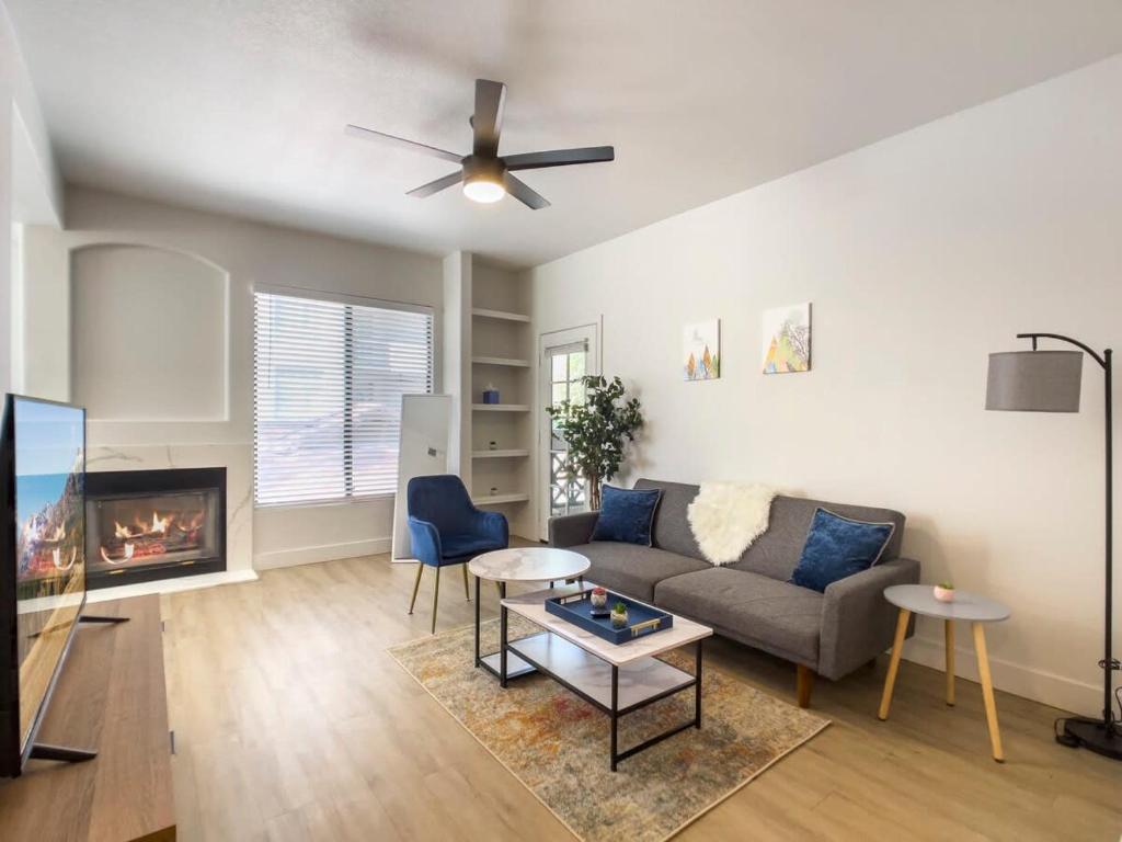a living room with a couch and a fireplace at 2BR Kierland Commons Golf Oasis by CozySuites! in Scottsdale