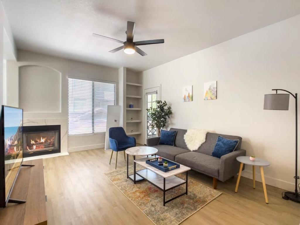a living room with a couch and a fireplace at 2BR Kierland Commons CozySuites by the golf course in Scottsdale