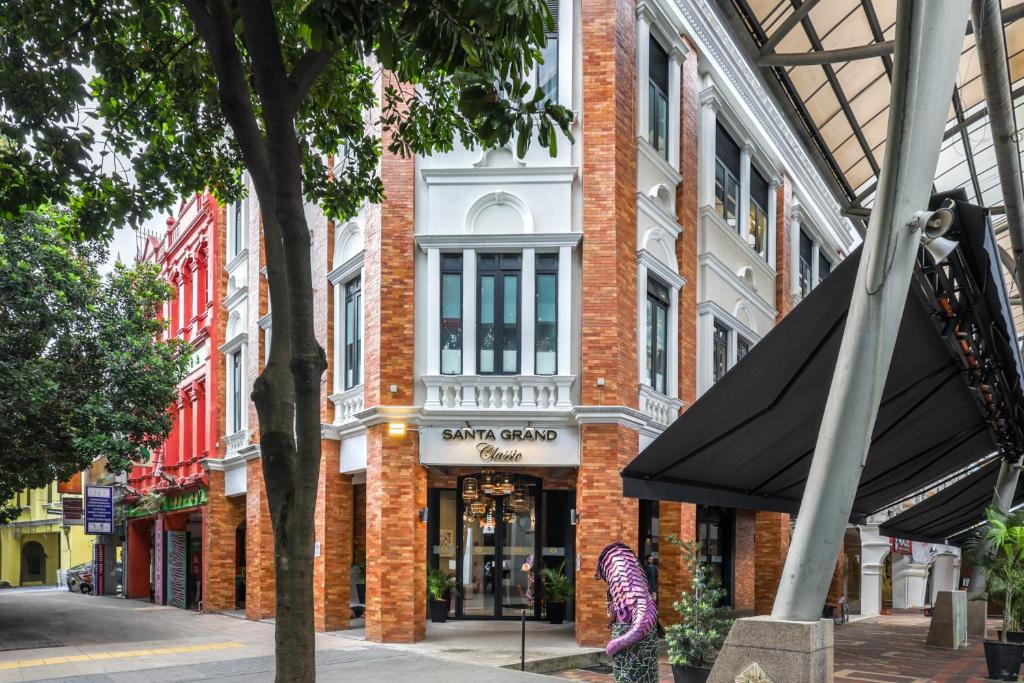 a brick building with a black umbrella in front of it at Santa Grand Classic Kuala Lumpur, Chinatown in Kuala Lumpur