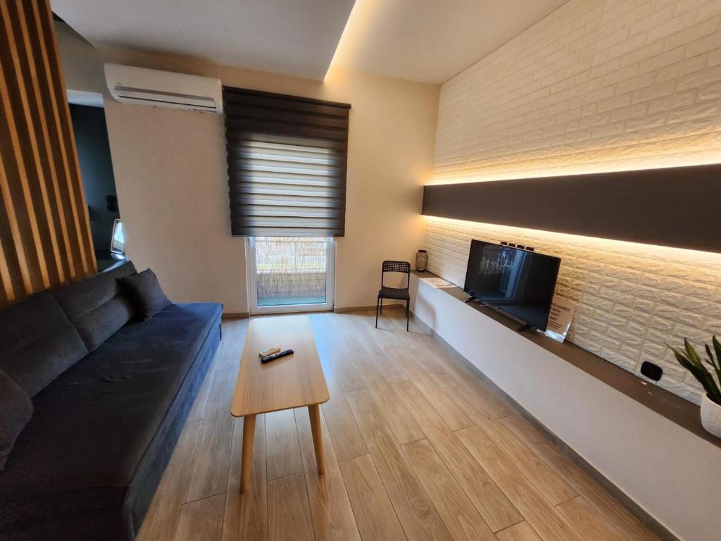 a living room with a couch and a tv at Luxury Apartment Acropolis Syggrou in Athens