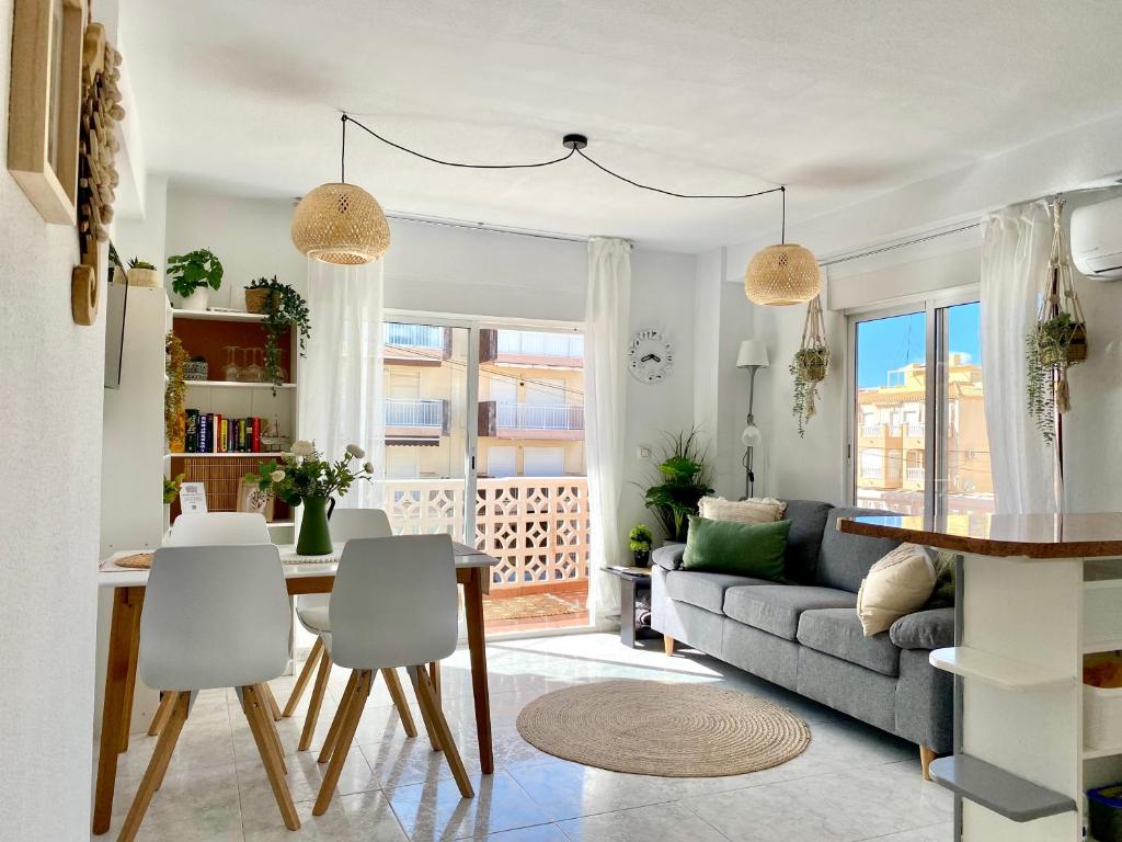 a living room with a couch and a table at Beach apartment 6 persons La Mata in La Mata