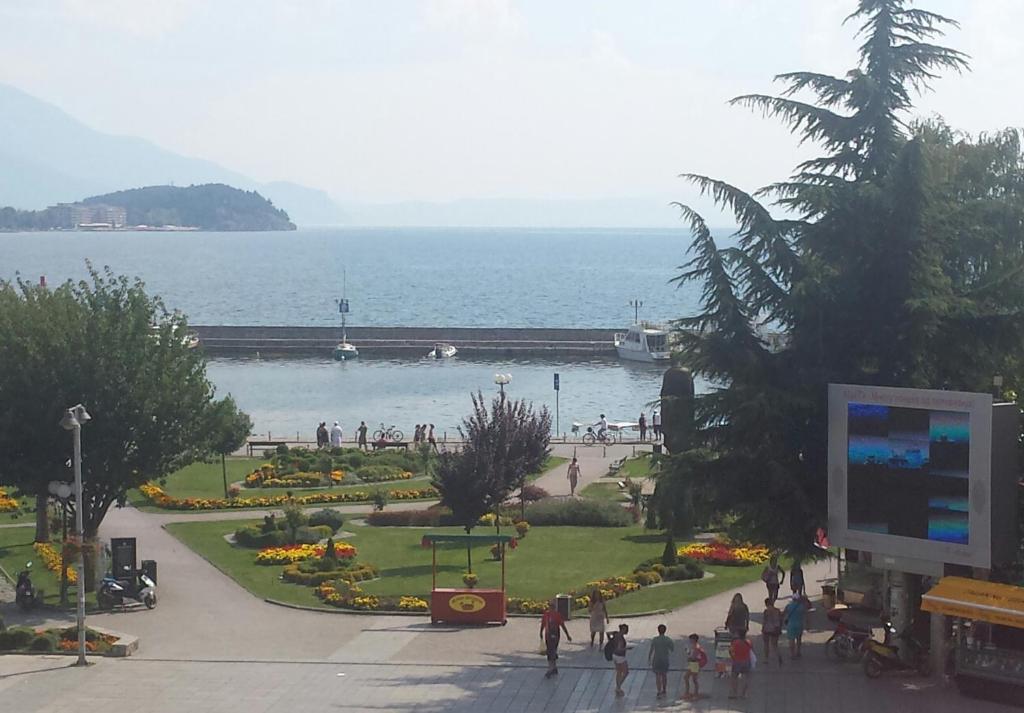 a group of people walking around a park near the water at Guest House Ginek in Ohrid