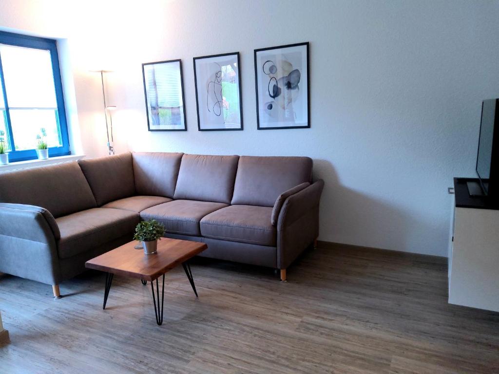a living room with a couch and a coffee table at Strandmuschel in Horumersiel