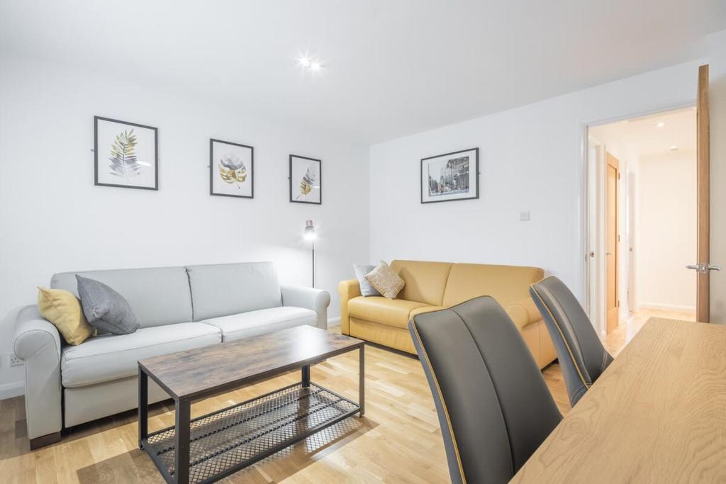 a living room with a couch and a table at Modern & Private - Free Parking in Cherry Hinton