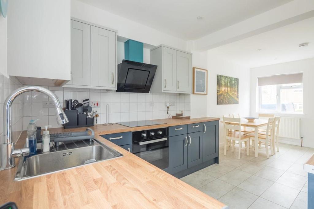 a kitchen with a sink and a counter top at Beautiful Family Home - Near River Cam in Cambridge