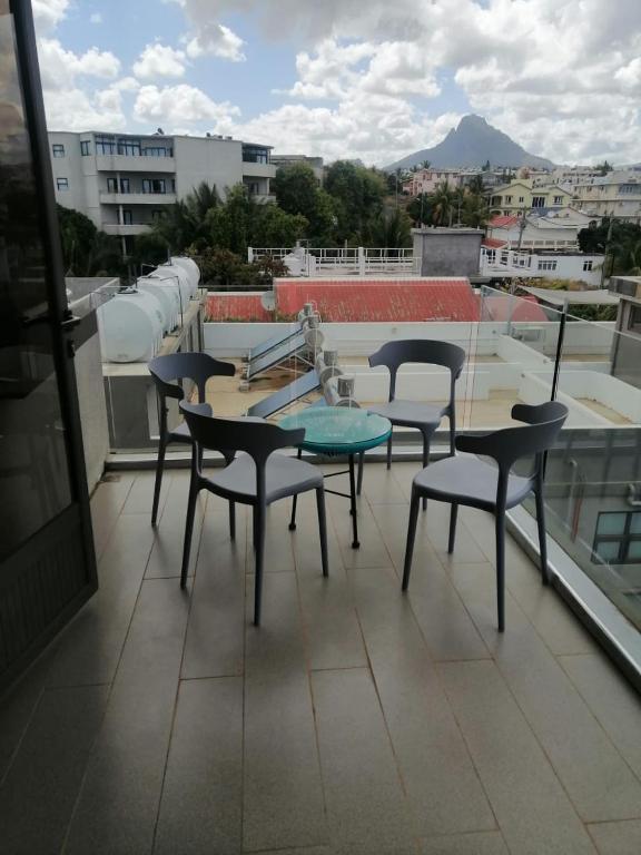 a group of chairs and a table on a roof at Enjoy Paradise Newave Holiday - Appartment No 8 in Flic-en-Flac