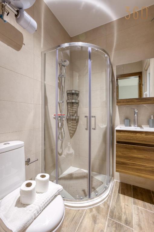 a shower in a bathroom with a toilet and a sink at Bright &amp; cosy 3BR home with private balcony &amp; WIFI by 360 Estates in Dingli