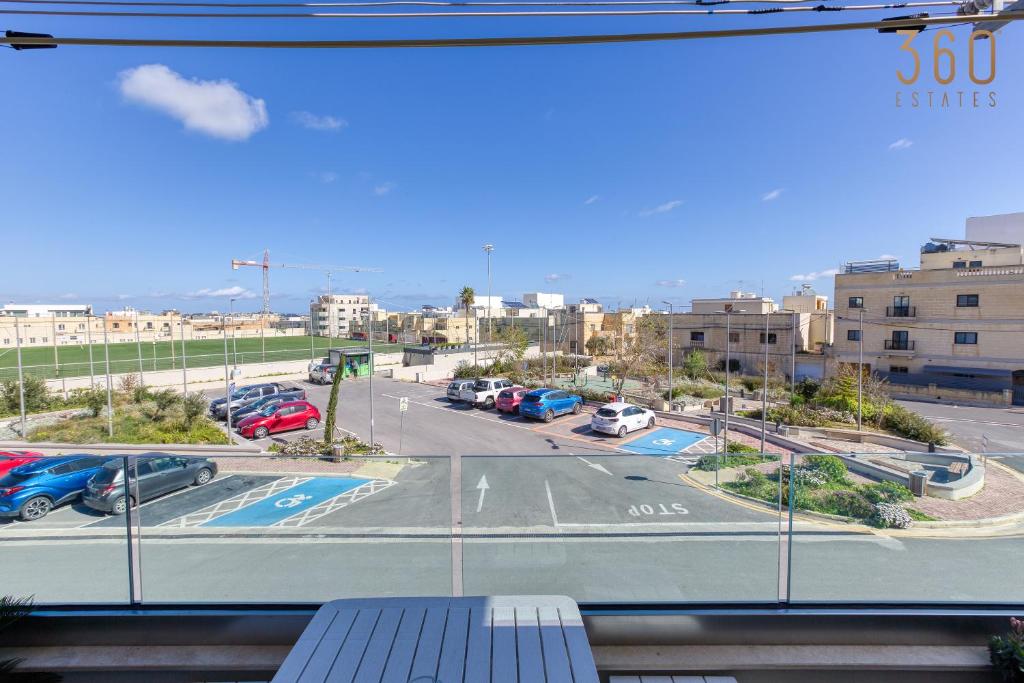 a view from a window of a parking lot at Bright &amp; cosy 3BR home with private balcony &amp; WIFI by 360 Estates in Dingli