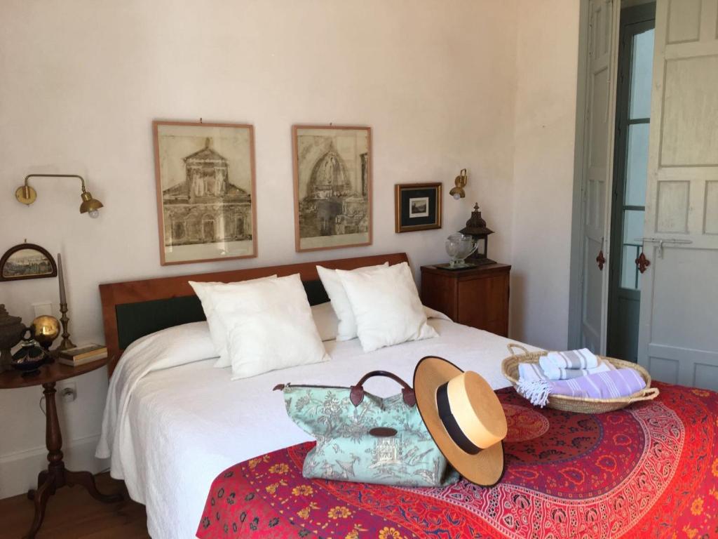 a bedroom with a bed with a hat on it at CASA PALACIO PRIVADO EN CADIZ CAPITAL - by Andalusian Glory in Cádiz