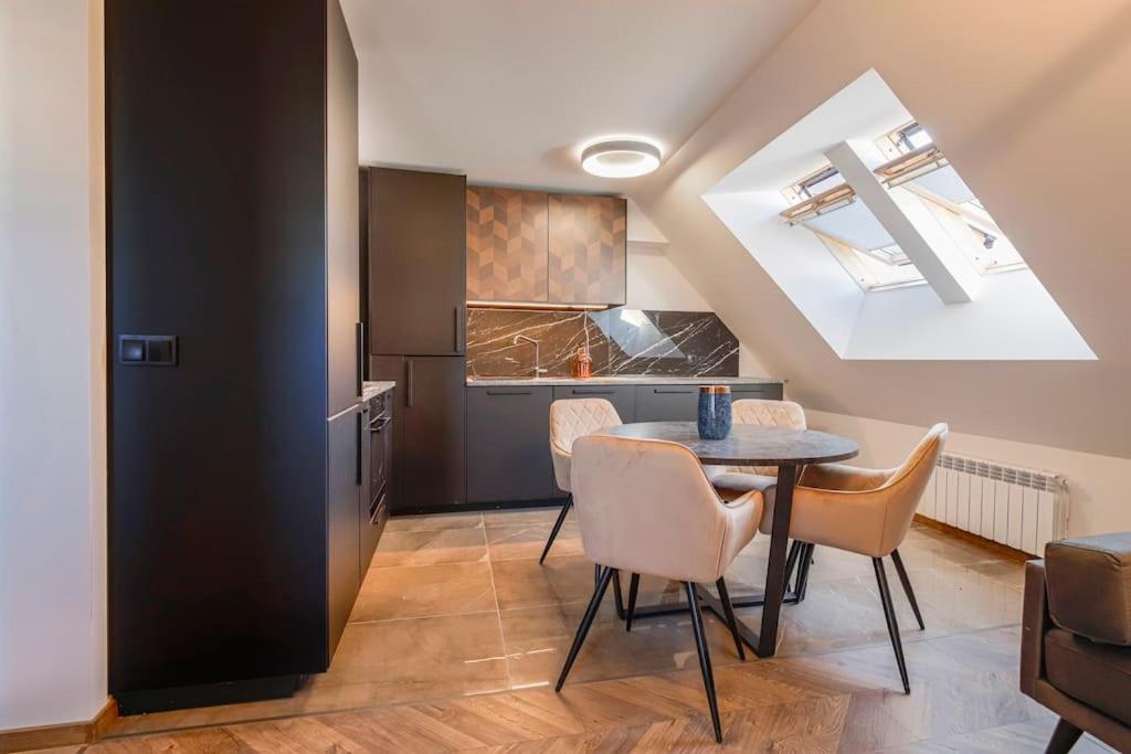 a kitchen and dining room with a table and chairs at 20% Discount! 2 Bedroom Apartment Vitosha View in Sofia