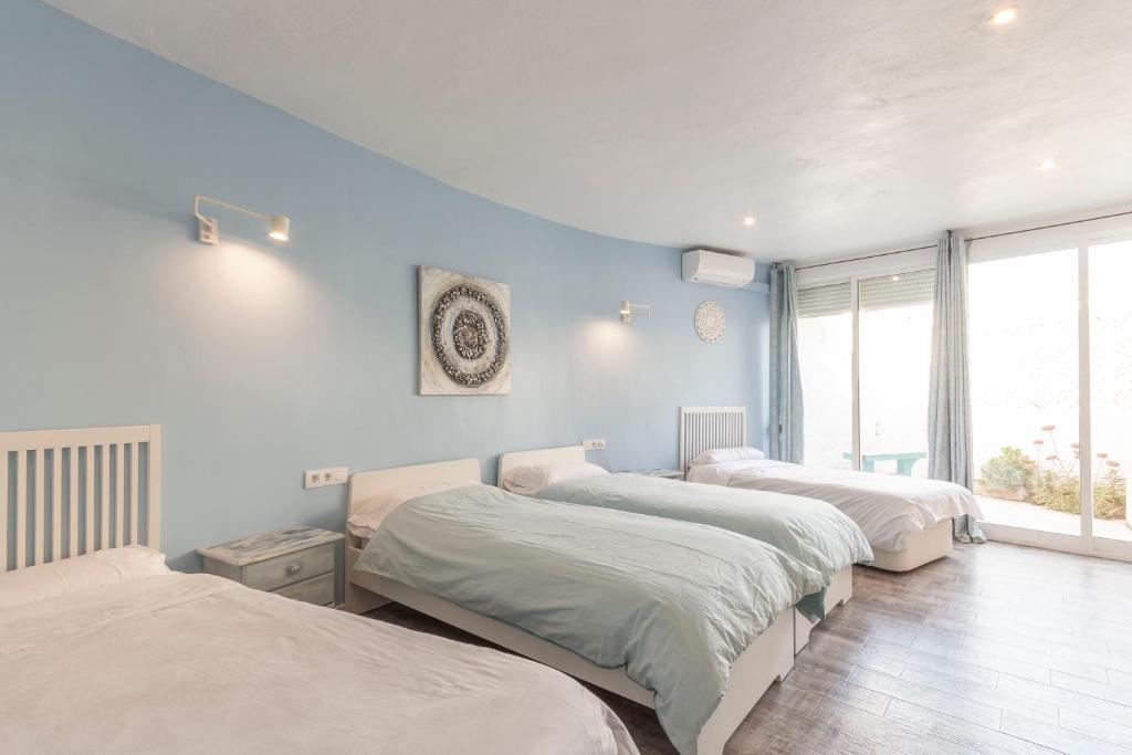 A bed or beds in a room at Villa Ronda - Costa CarpeDiem