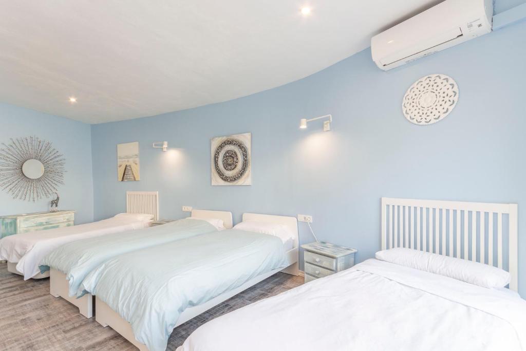 A bed or beds in a room at Villa Ronda - Costa CarpeDiem