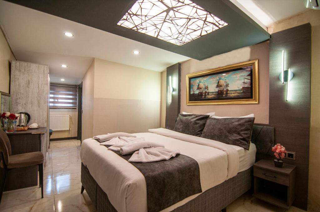 a bedroom with a large bed with a skylight at yakut old ctiy in Istanbul