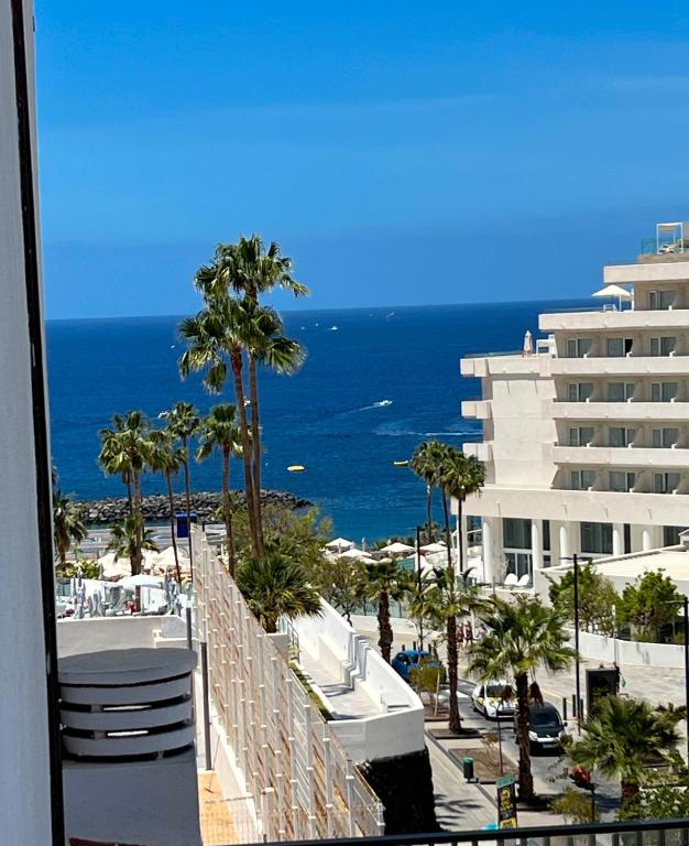 a view of the ocean from the balcony of a building at Tenerife Paradise Anna Studio in Adeje