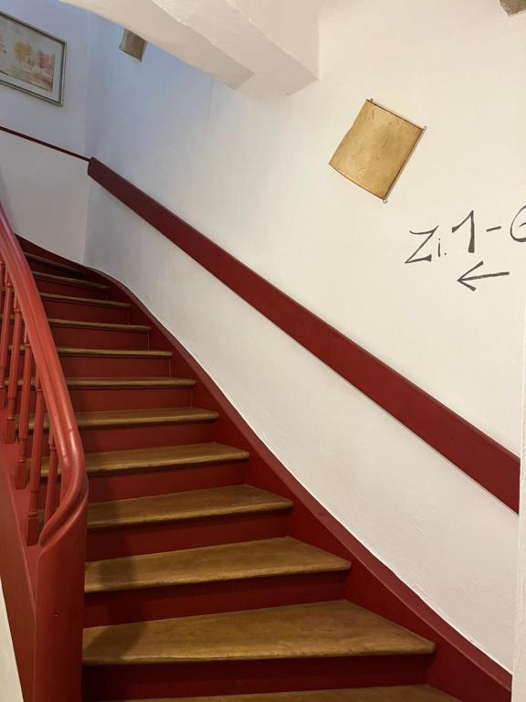 a staircase in a building with a sign on the wall at Hotel Weinstube am Markt in Gerolzhofen