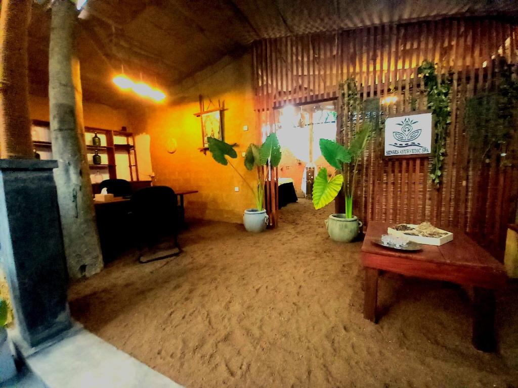 a room with potted plants and a table in a room at Selnara Private Luxury Villa and Ayurveda Spa in Bentota