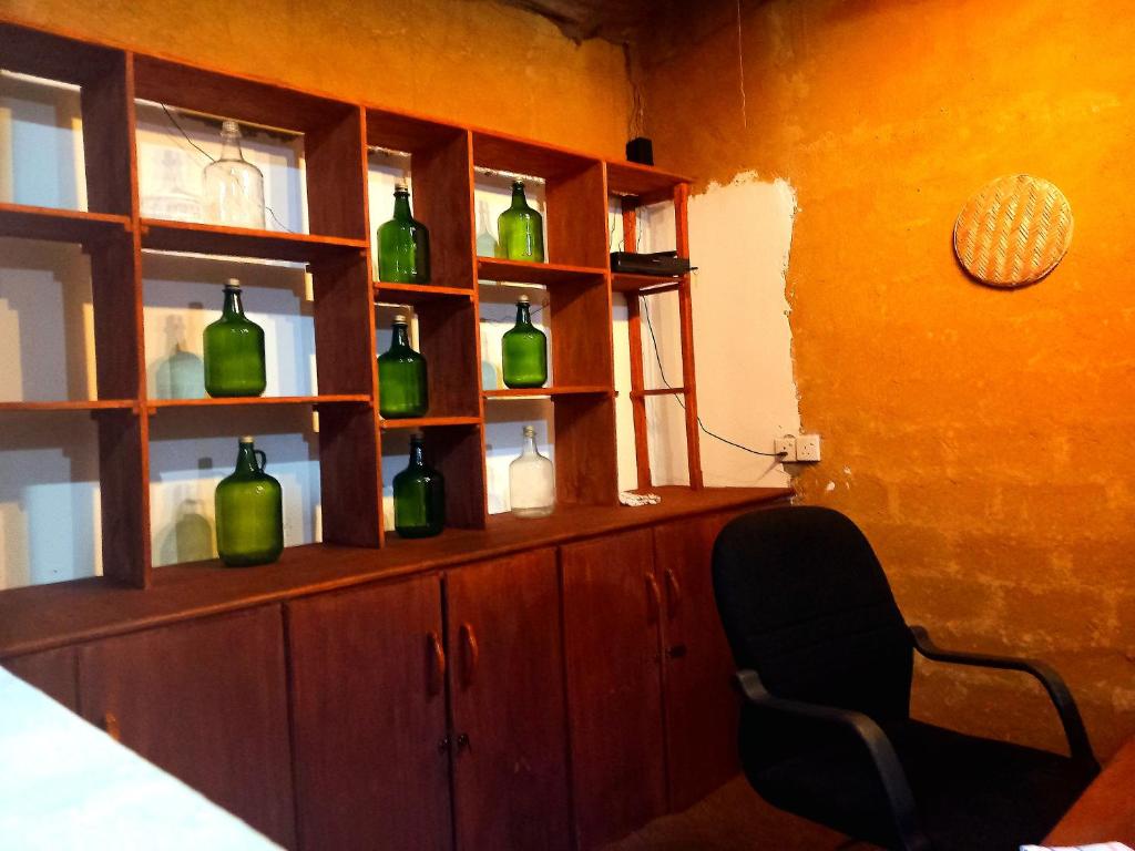 a room with a shelf with green bottles on it at Selnara Private Luxury Villa and Ayurveda Spa in Bentota