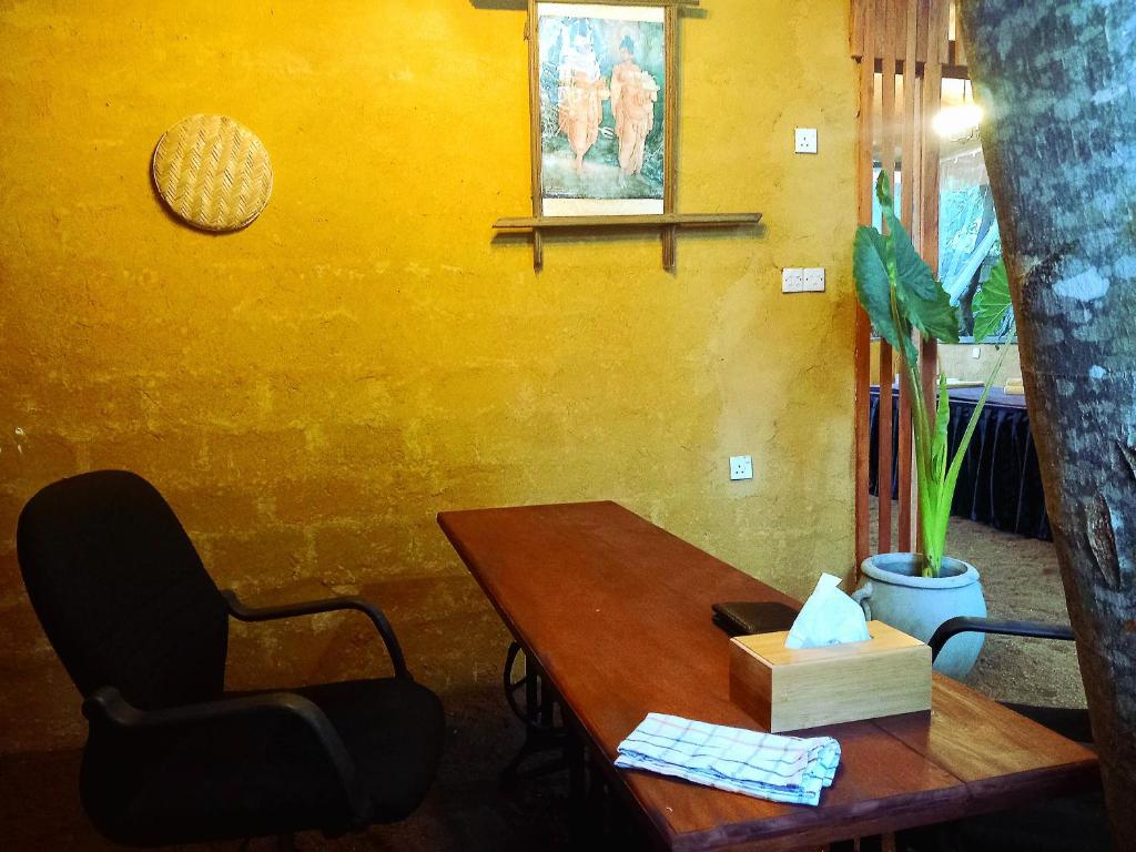 a table and a chair in a room with a table at Selnara Private Luxury Villa and Ayurveda Spa in Bentota