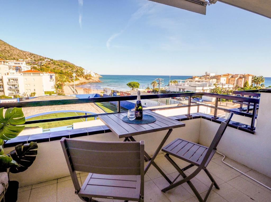 a balcony with a table and chairs and the ocean at The Beach Studio by Hello Homes Sitges in Sitges