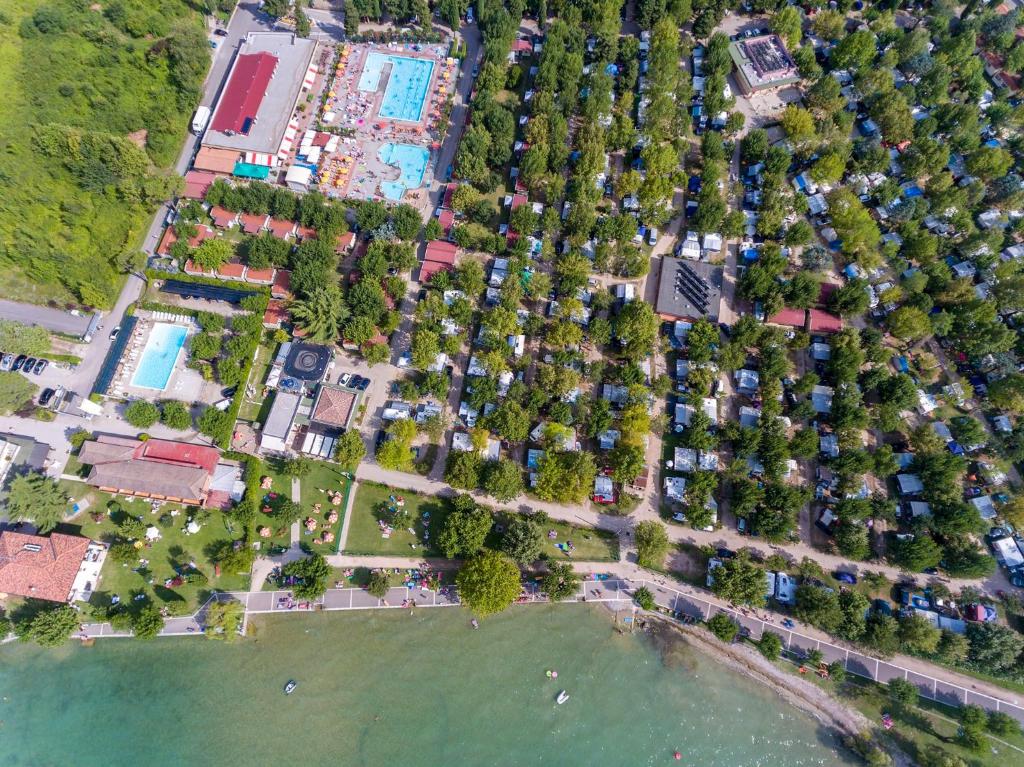 an aerial view of a park next to the water at Campeggio Gasparina in Castelnuovo del Garda