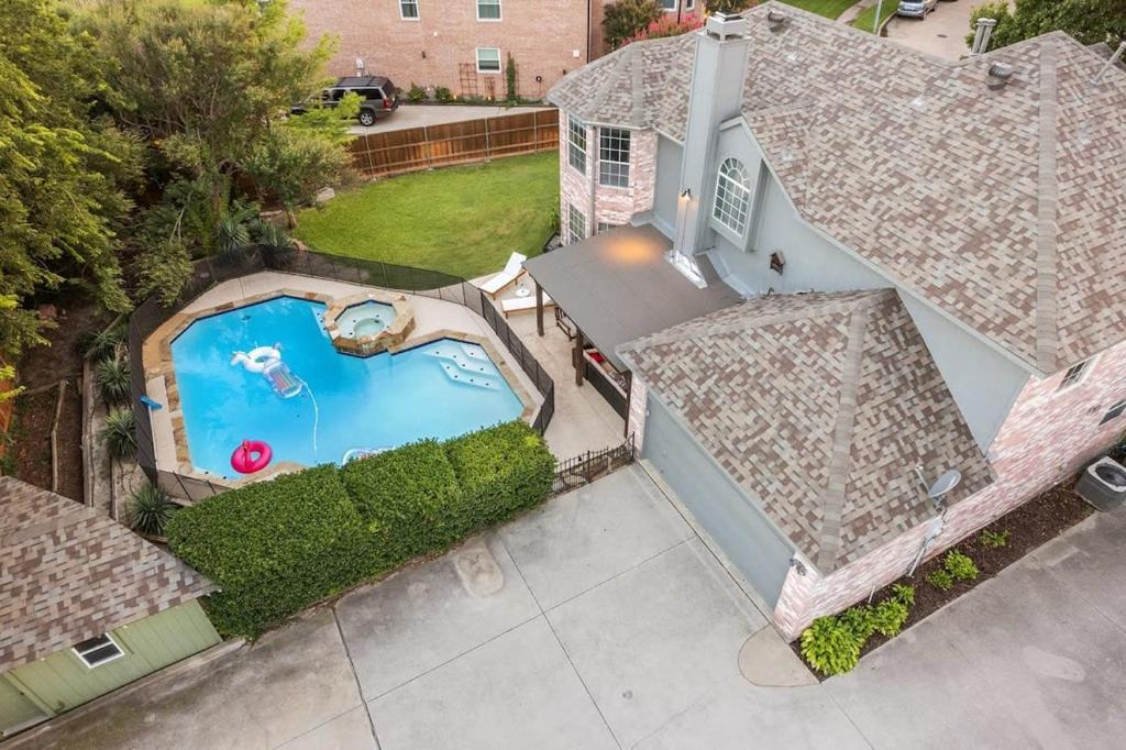 an overhead view of a house with a swimming pool at Heated Pool PoolTable HotTub Sleeps 16 Renovated in McKinney