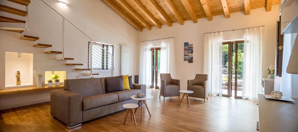 a living room with a couch and two chairs at Residence Mare Azzurro Sistiana in Sistiana