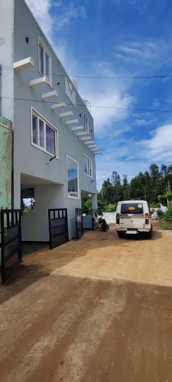 a white van parked in front of a building at Silver Oak stay in Yercaud