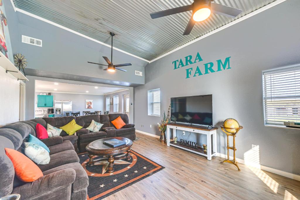 a living room with a couch and a flat screen tv at 4 Mi to Whitney Lake Home on 30 Acres! in Whitney